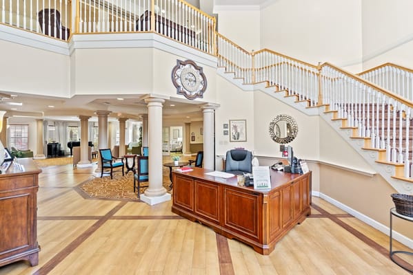Lobby reception area with wooden desk and stairs