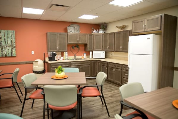 Cozy dining area with tables, chairs, and kitchenette