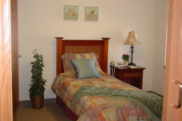 Cozy private resident room with decorative quilt