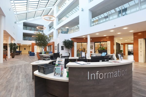 Modern information desk in a senior living facility lobby