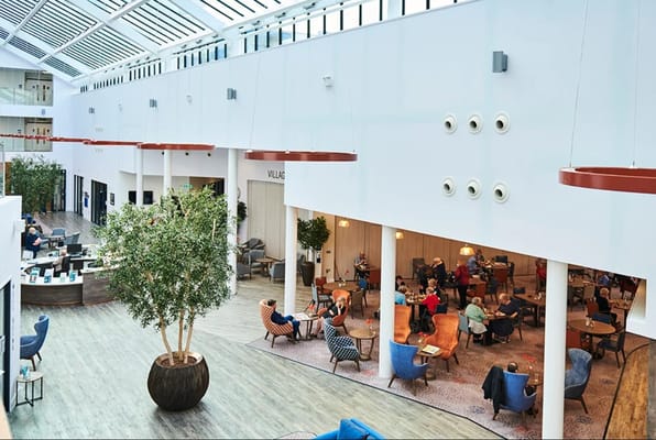 Spacious lounge area with residents socializing and enjoying refreshments