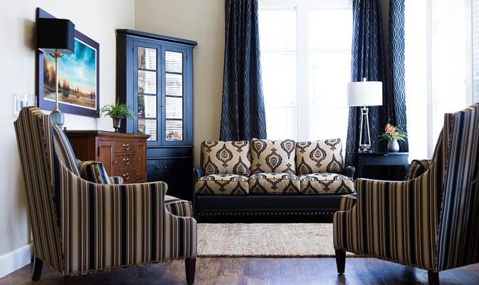 Comfortable living room with a patterned sofa and armchairs