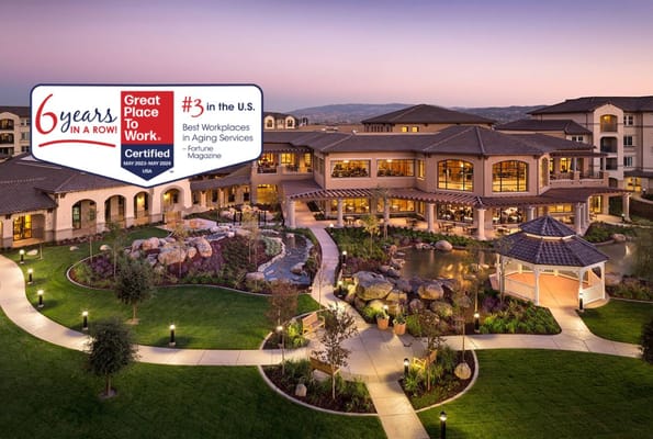Exterior view of Stoneridge Creek Pleasanton with landscaped gardens and gazebo at dusk