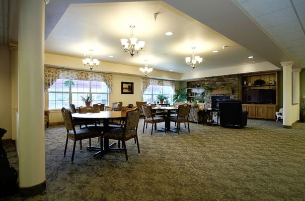 Spacious living room with tables and chairs in Stonegate Village