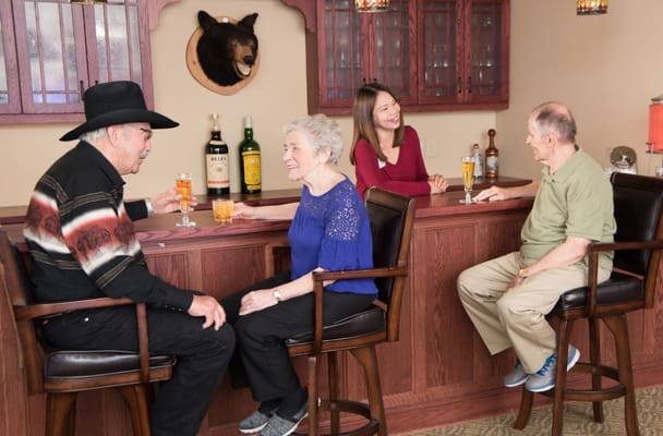 Residents enjoying drinks at the facility bar area