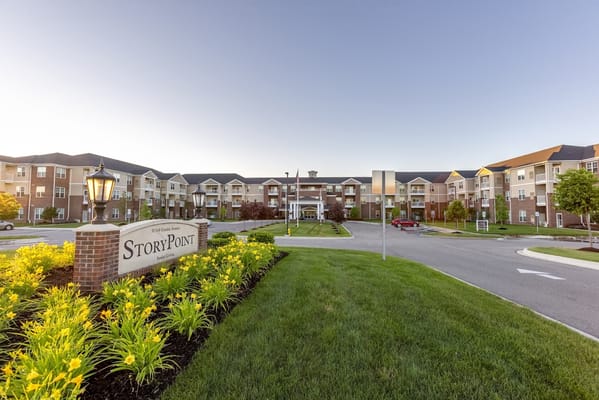 Entrance to StoryPoint Chesterfield with landscaped flowers and signage.