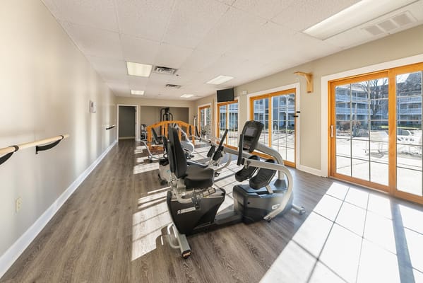 Fitness center with exercise equipment and large windows