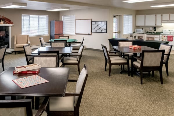 Common area with tables and chairs for activities