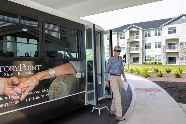 A resident walking out of a transportation vehicle at StoryPoint Fairfield.
