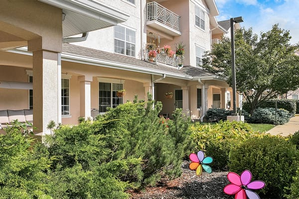 Colorful garden decorations and lush landscaping in front of StoryPoint Louisville East
