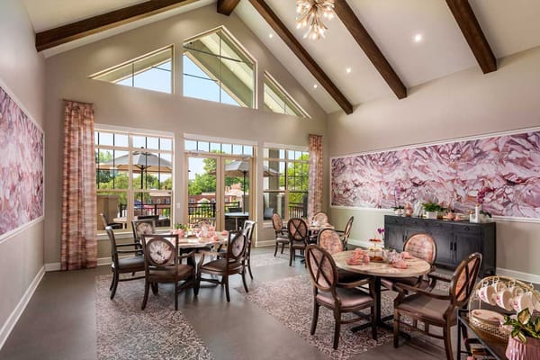 Bright and inviting dining room with tables set for a meal