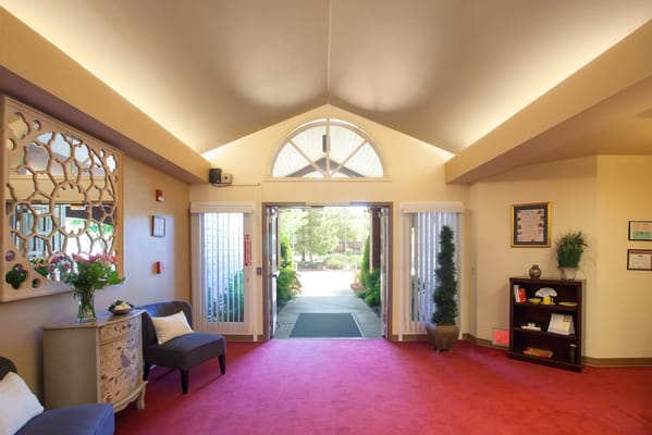 Welcoming entrance area with a carpet and plants