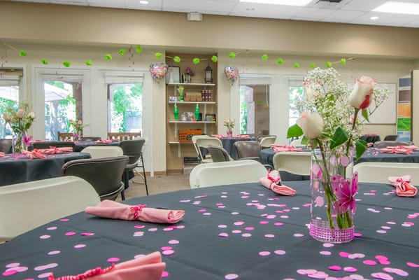Decorated dining room with tables set for an event.