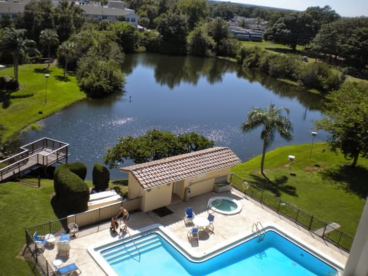 View of the community pool overlooking a serene lake