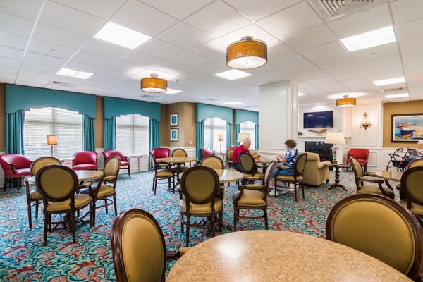 Residents socializing in a common area with seating
