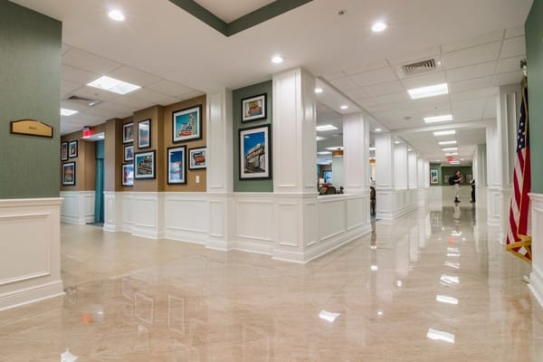 Interior hallway of a senior living facility with artwork