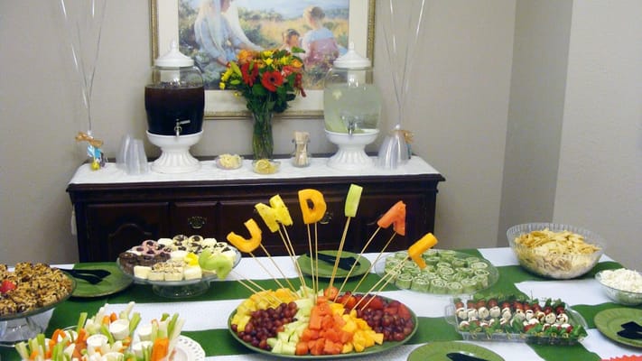 A colorful spread of fruits and snacks with decorative fruit letters spelling 'Sundial'.