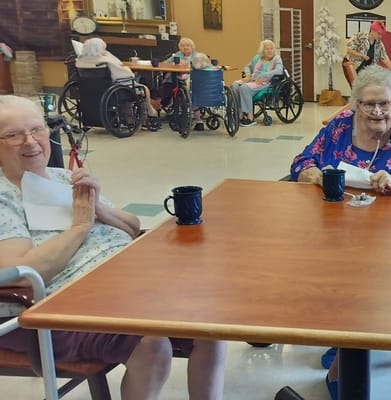 Residents enjoying a social activity at a table