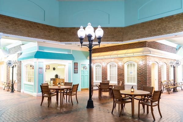 Common area with wooden tables and light fixtures at Superior Residences of Brandon