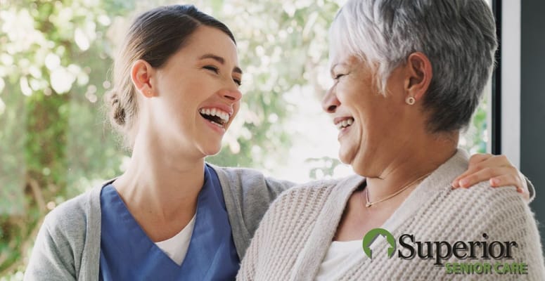 A staff member and a resident sharing a joyful laugh together.