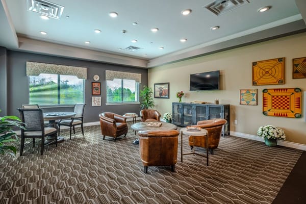 A cozy living room with seating and natural light at Tech Ridge Oaks Assisted Living.
