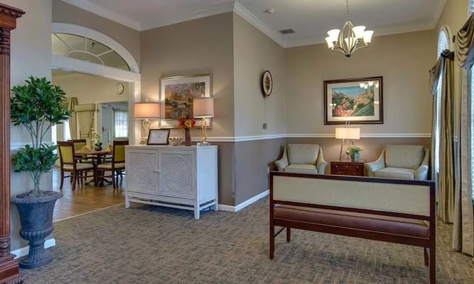 A welcoming living room with seating and decorative plants.
