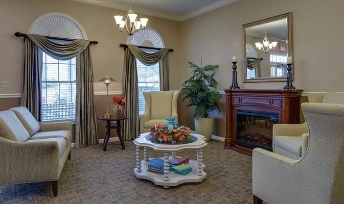 A cozy living room with plush seating and a fireplace.