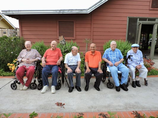 Group of seniors sitting in wheelchairs outside at The Bridges at Edinburg