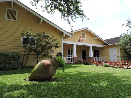 Front view of The Bridges at Edinburg assisted living facility with decorative planter