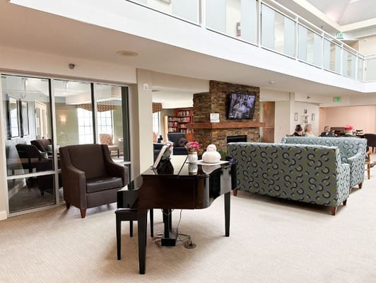 Interior view of a common area with piano and seating