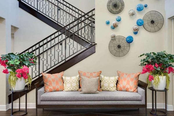 Comfortable seating area with decorative pillows and wall art