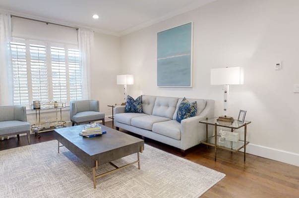Elegant living room with a gray sofa, decorative pillows, and a coffee table.