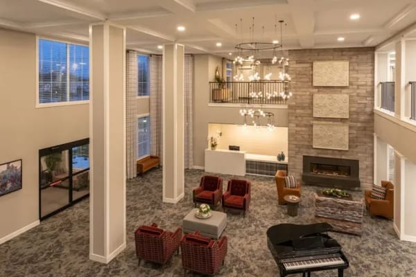 Spacious lobby area with seating and a grand piano