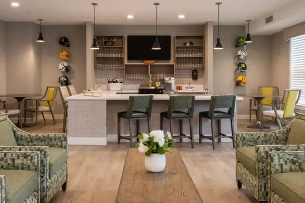 Modern common area with a bar and seating at The Esther at Riverbend