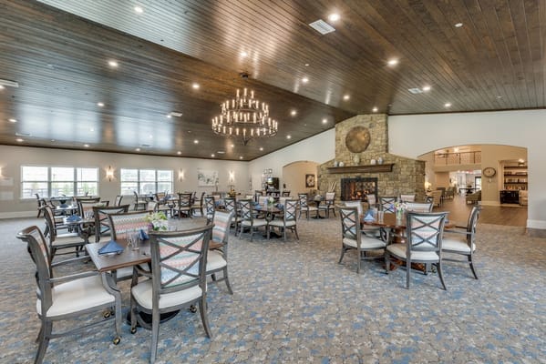Spacious dining area with tables and a stone fireplace
