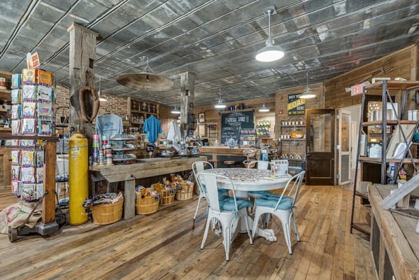 Interior view of a cozy cafe with wooden furniture and vintage decor at The Fountains.