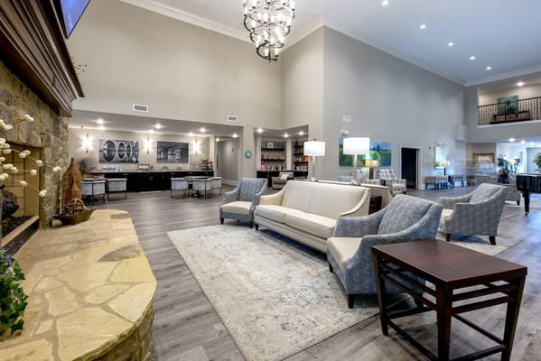 Spacious lobby with seating and a stone fireplace