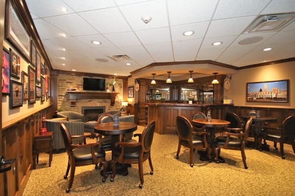 Cozy lounge area with dining tables and a fireplace