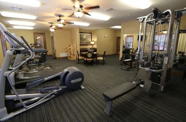 Well-equipped fitness center with exercise machines and seating area