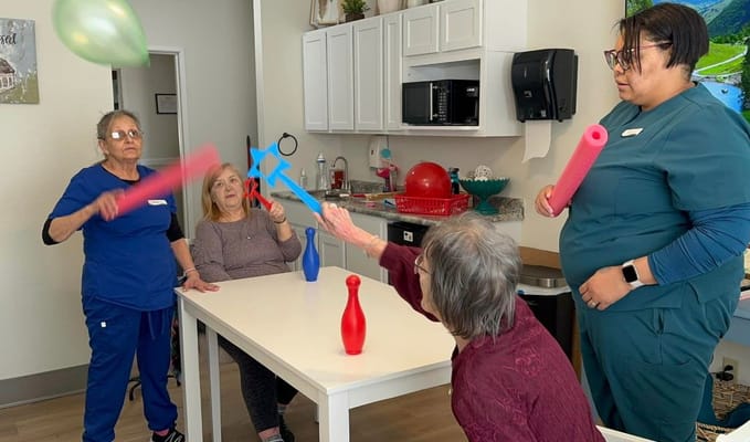 Seniors participating in a playful activity with colorful foam sticks
