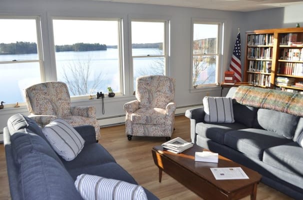 Living room with windows overlooking a serene river view