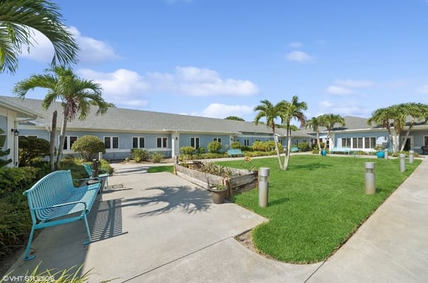 Outdoor area with benches and landscaped garden