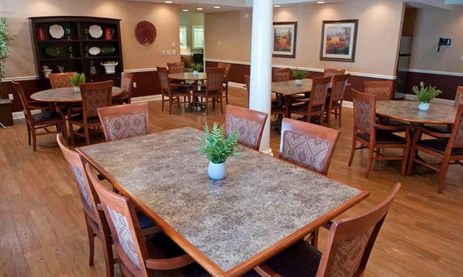 Well-lit dining area with multiple tables and chairs