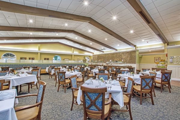 Spacious dining area with tables set for meals