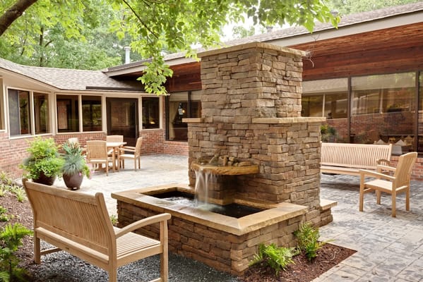 Outdoor courtyard with a stone fountain and seating