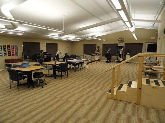 Interior view of the therapy room with various equipment and desks
