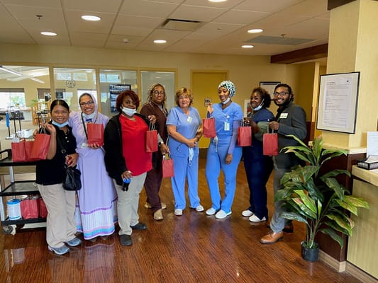 Staff members holding red bags at The Orchards Michigan.