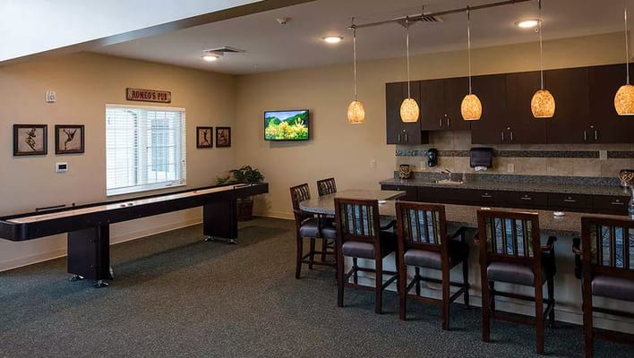 Modern kitchen with bar seating and shuffleboard.