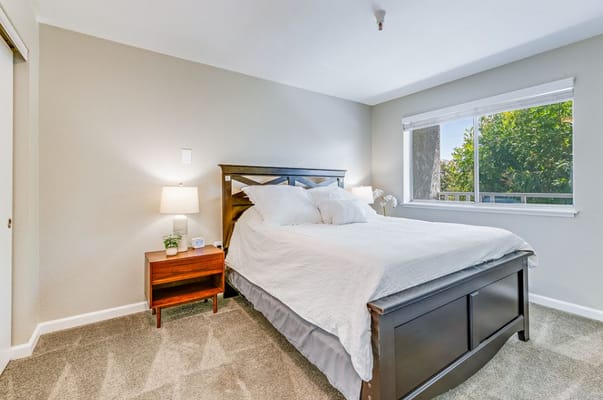 Well-furnished bedroom with a bed and bedside table