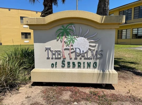 Sign for The Palms at Sebring with palm tree and sun design